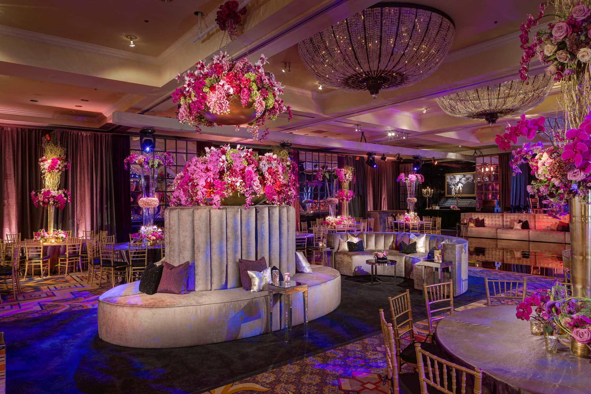 Dramatic ballroom lounge with suspended florals and crystal chandeliers