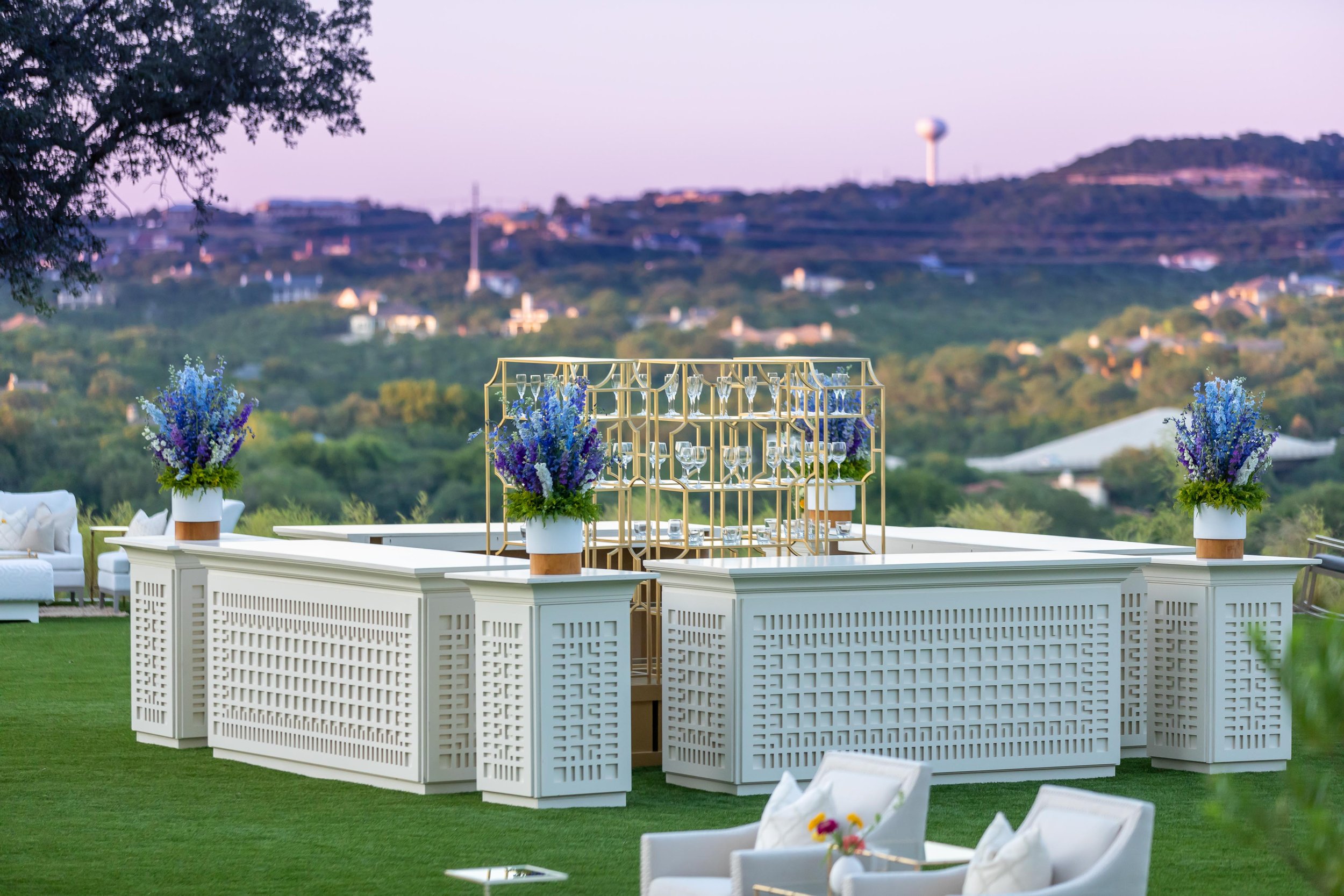 Outdoor cocktail bar at dusk overlooking the Austin hill country